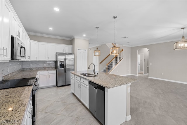 kitchen with pendant lighting, sink, an island with sink, white cabinetry, and stainless steel appliances