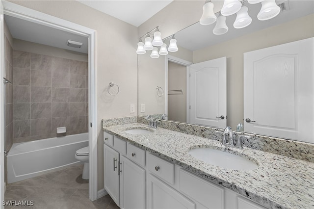 full bathroom featuring tile patterned flooring, vanity, toilet, and tiled shower / bath