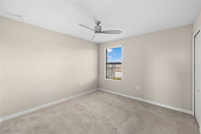 spare room featuring light carpet