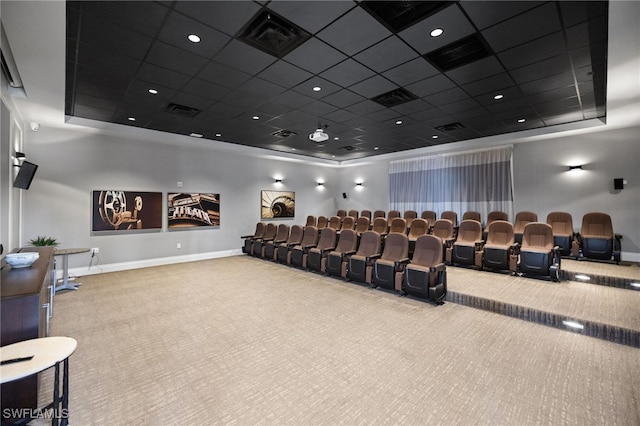 cinema room with a drop ceiling and light colored carpet