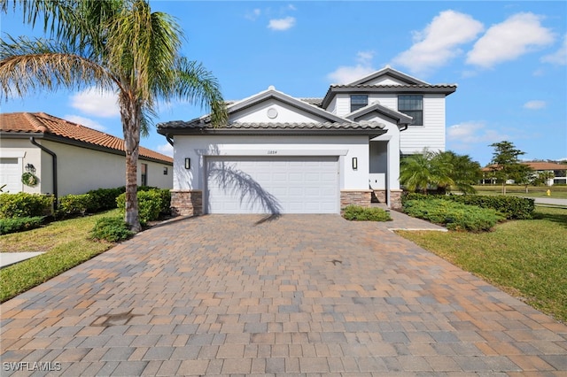 view of front of property with a front yard and a garage