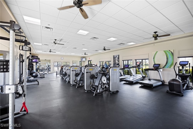 workout area with plenty of natural light and a drop ceiling