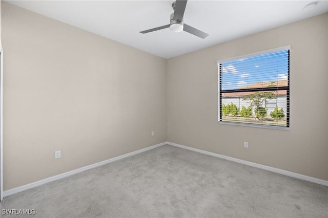 carpeted empty room featuring ceiling fan