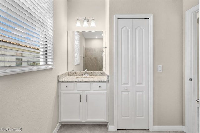 bathroom featuring vanity and a tile shower