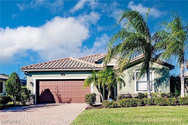 view of front of home with a garage and a front lawn