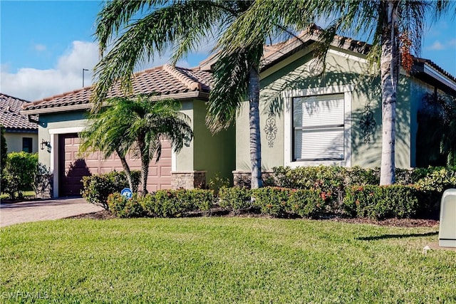 mediterranean / spanish-style house with a front lawn and a garage