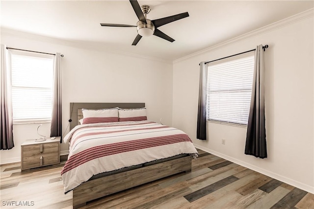 bedroom featuring light hardwood / wood-style flooring, ceiling fan, and crown molding