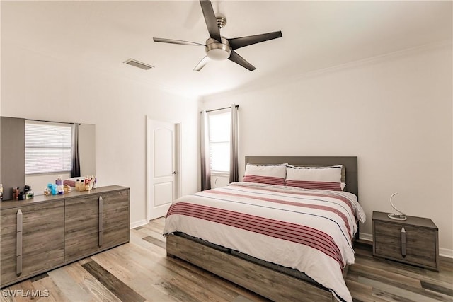 bedroom with ceiling fan and light wood-type flooring