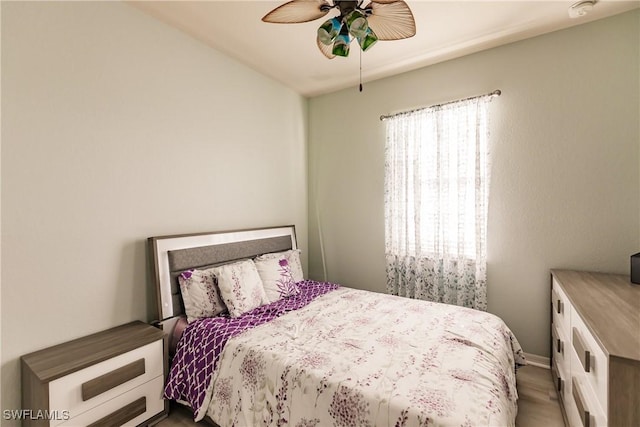 bedroom with hardwood / wood-style floors and ceiling fan