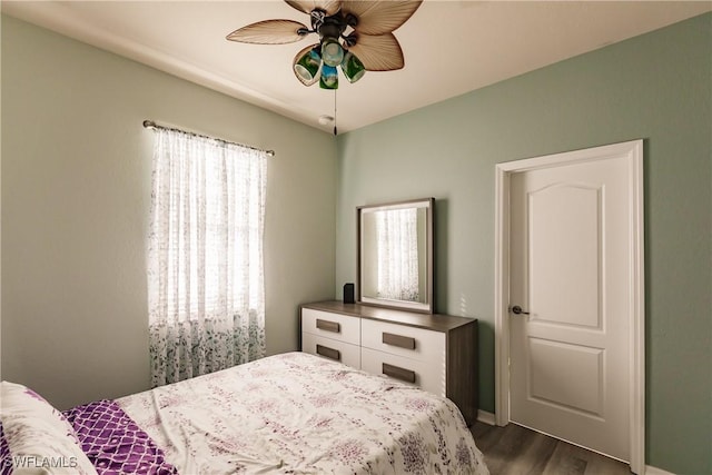 bedroom featuring ceiling fan and dark wood-type flooring