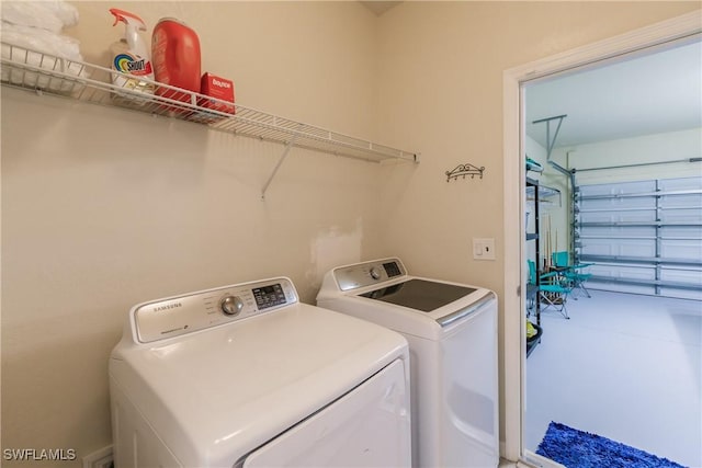 clothes washing area with washer and dryer