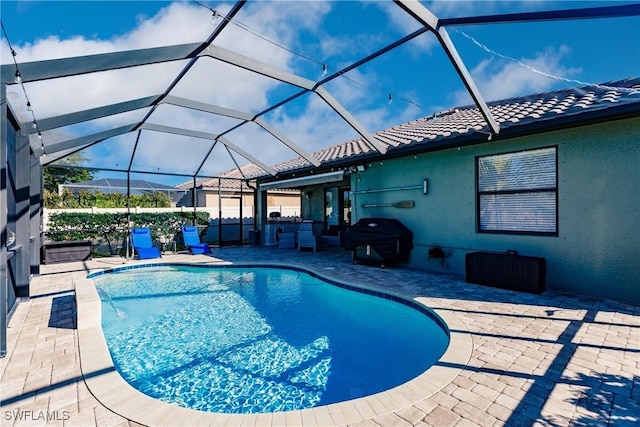 view of pool featuring area for grilling, a lanai, and a patio