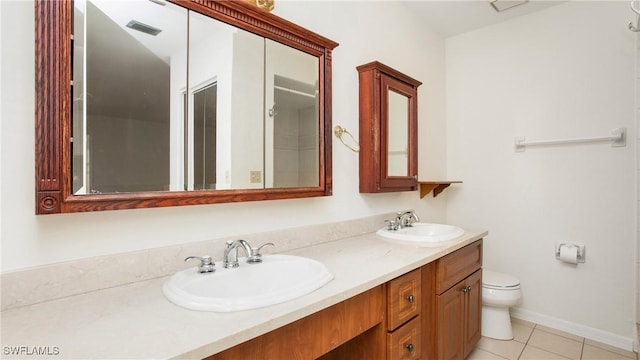 bathroom with tile patterned flooring, vanity, and toilet