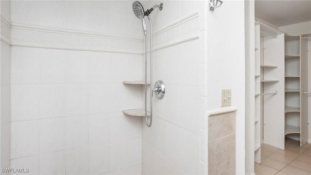 bathroom with tile patterned flooring and walk in shower