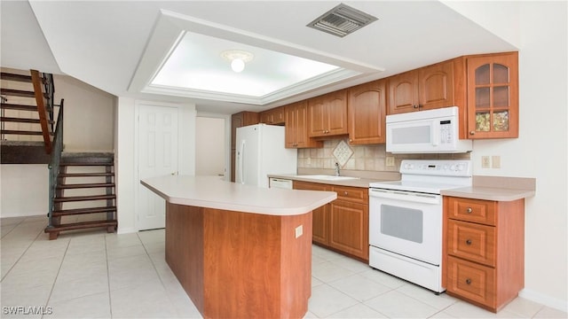 kitchen with a center island, white appliances, backsplash, sink, and light tile patterned floors