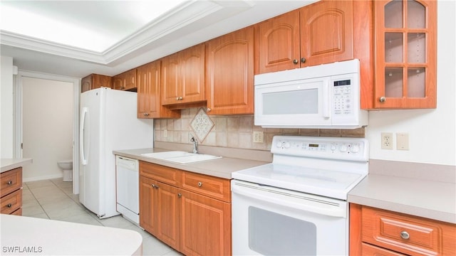 kitchen featuring tasteful backsplash, ornamental molding, white appliances, sink, and light tile patterned flooring