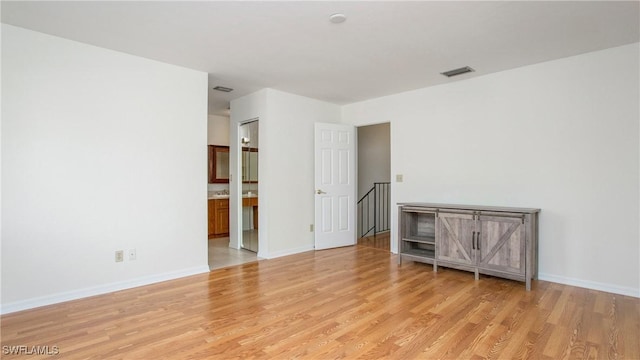 unfurnished room with light wood-type flooring