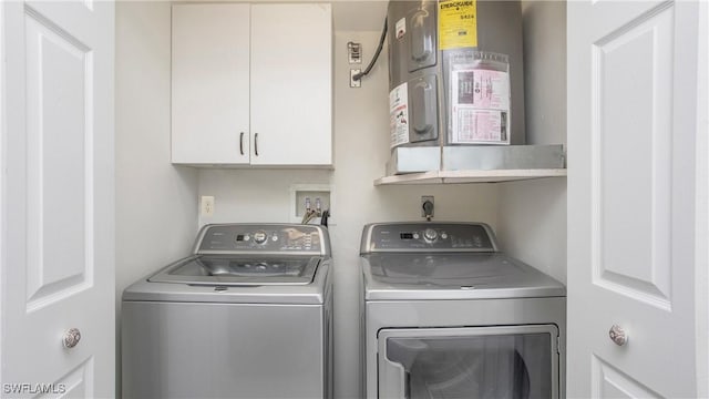 washroom with cabinets and washing machine and clothes dryer