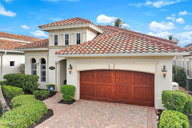 mediterranean / spanish home with a garage