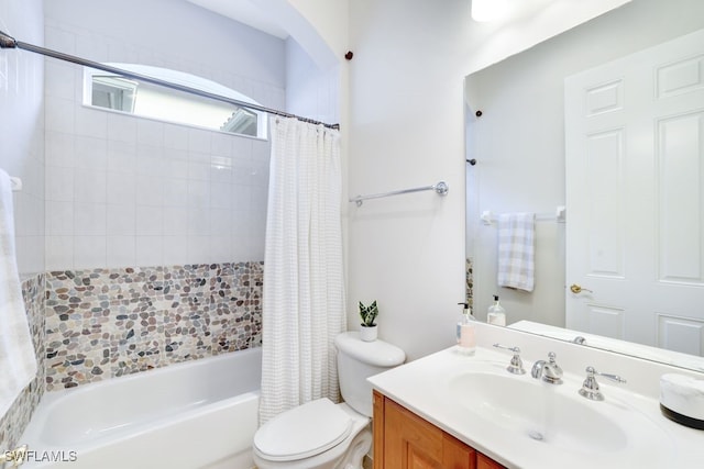 full bathroom with shower / bath combo with shower curtain, vanity, and toilet