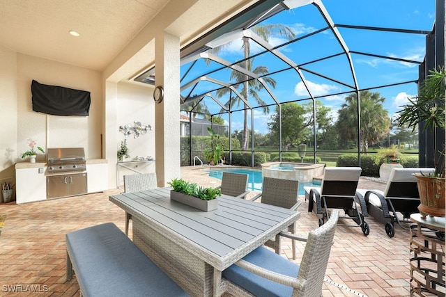 view of patio / terrace with a grill, exterior kitchen, a pool with hot tub, and glass enclosure