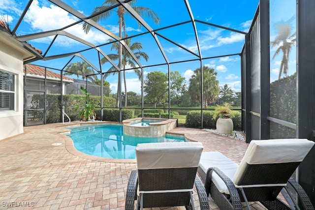 view of pool with a lanai, a patio area, and an in ground hot tub