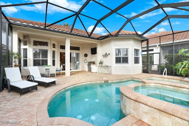 view of swimming pool with a lanai, an in ground hot tub, and a patio