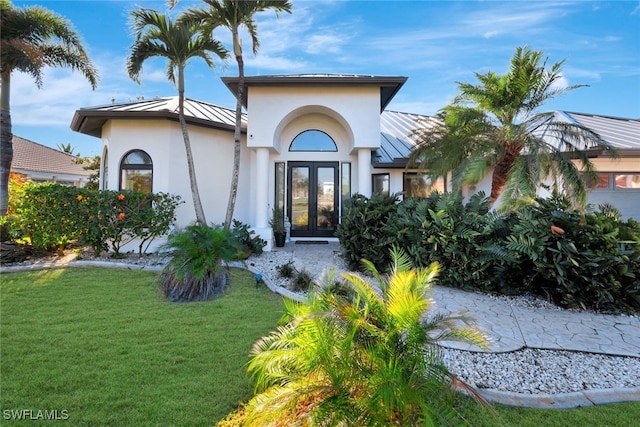 exterior space with a front lawn and french doors