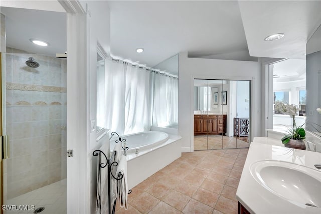 bathroom with vanity, tile patterned floors, and plus walk in shower