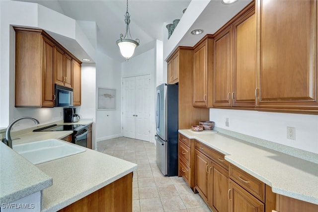 kitchen featuring pendant lighting, appliances with stainless steel finishes, sink, and light tile patterned floors