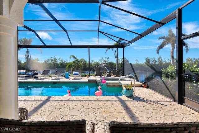 view of swimming pool with glass enclosure and a patio area