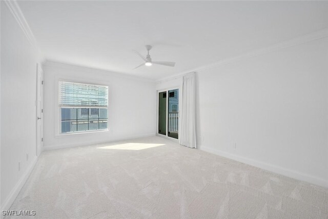 spare room featuring ceiling fan, ornamental molding, and light carpet