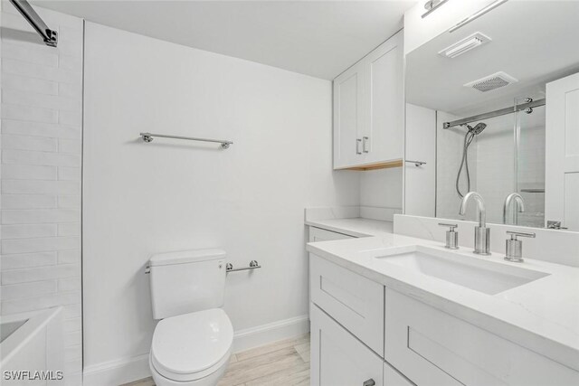 bathroom with hardwood / wood-style floors, vanity, and toilet