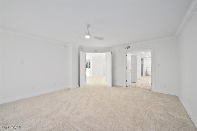 carpeted empty room with ceiling fan and ornamental molding