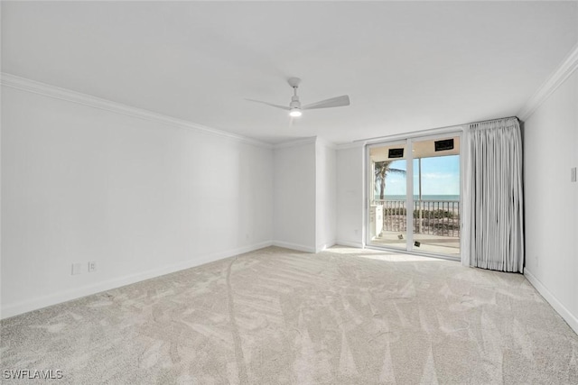 carpeted empty room with ceiling fan and crown molding