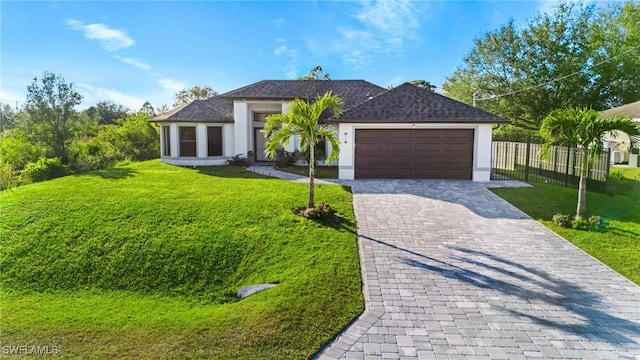 view of front of home featuring a front lawn and a garage