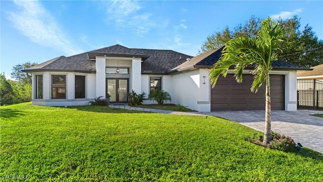 view of front facade featuring french doors, a garage, and a front lawn