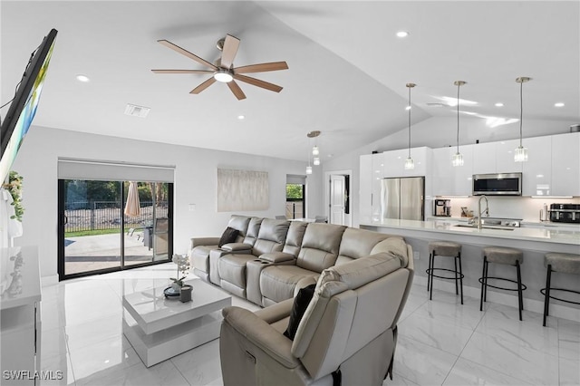 living room with sink, vaulted ceiling, ceiling fan, and plenty of natural light