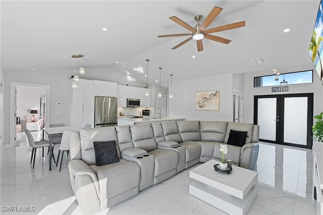 living room with lofted ceiling, sink, ceiling fan, and french doors