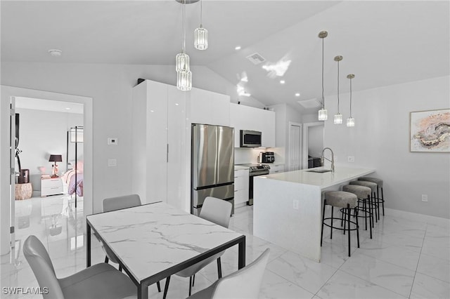 dining area with lofted ceiling and sink