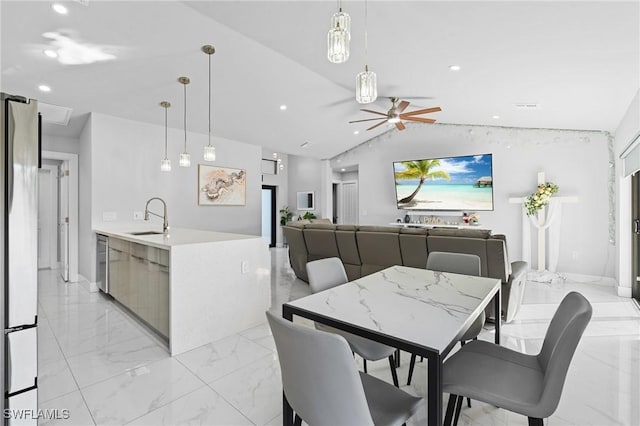 dining area with sink, vaulted ceiling, and ceiling fan