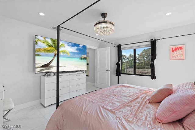 bedroom featuring a notable chandelier