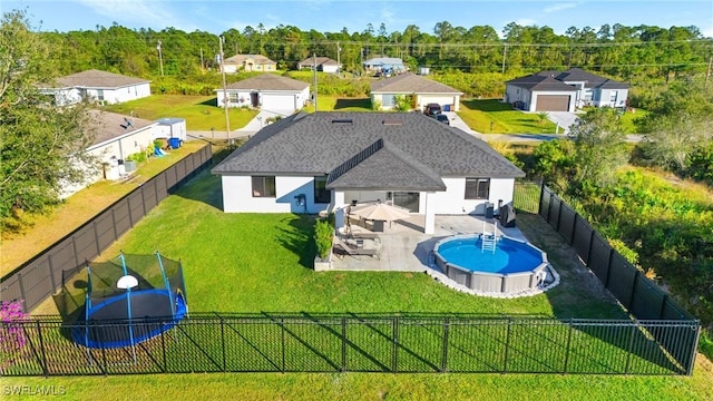 view of swimming pool with a trampoline, a patio, and a lawn