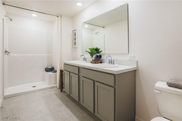 bathroom featuring walk in shower, tile patterned floors, vanity, and toilet