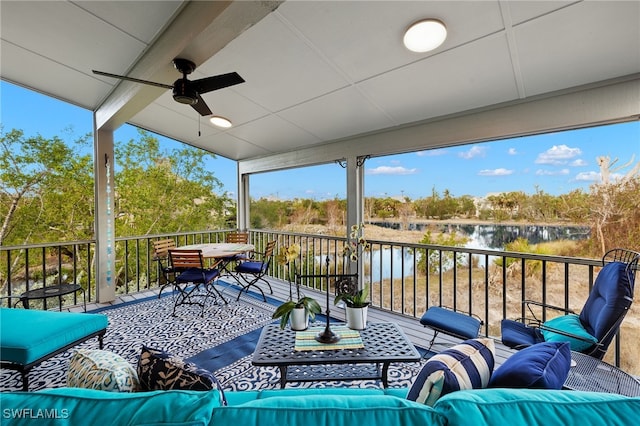 exterior space featuring ceiling fan, a water view, and a balcony