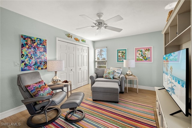 sitting room featuring ceiling fan and light wood-type flooring