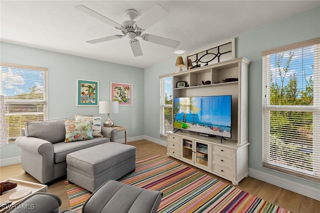 living room with light hardwood / wood-style floors and ceiling fan