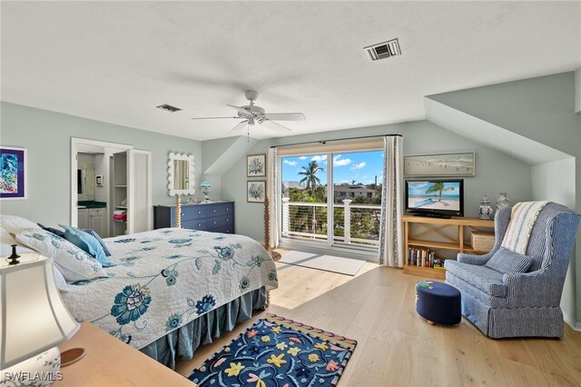 bedroom featuring connected bathroom, ceiling fan, hardwood / wood-style floors, and vaulted ceiling