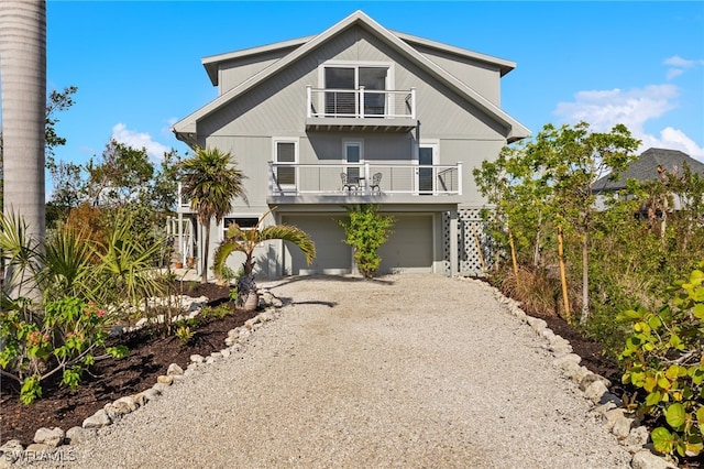 view of front of property featuring a garage and a balcony