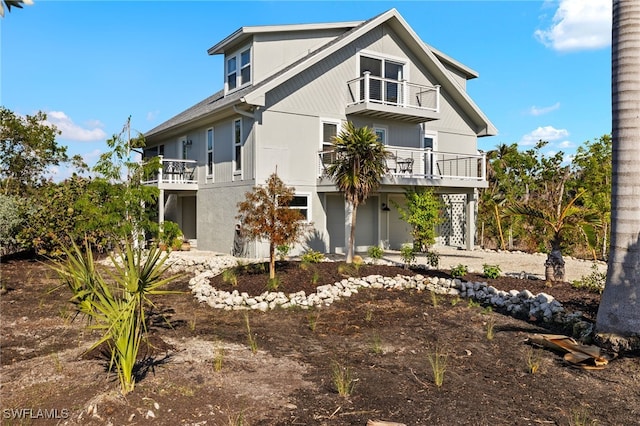 view of front of home featuring a garage and a balcony